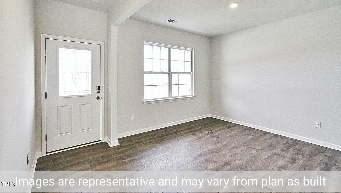 1702 Carter Daniel Drive Graham, NC 27253 - Photo 3 of 27 an empty room with wooden floor and windows