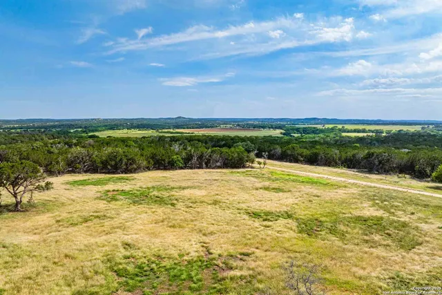 a view of a field with an ocean beach