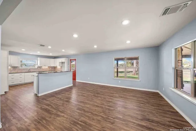 a kitchen with granite countertop white cabinets and white appliances