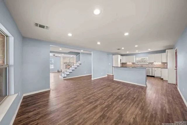 a kitchen with granite countertop cabinets stainless steel appliances and a sink