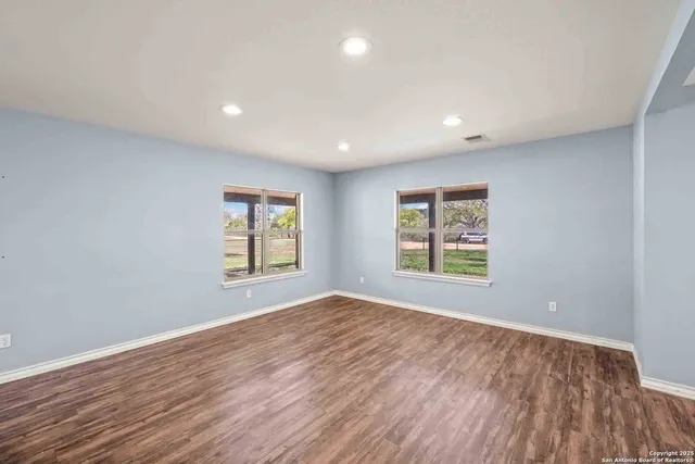 a view of staircase with wooden floor and a fireplace