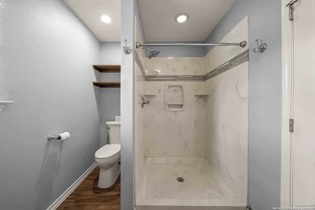 an empty room with windows and painted walls