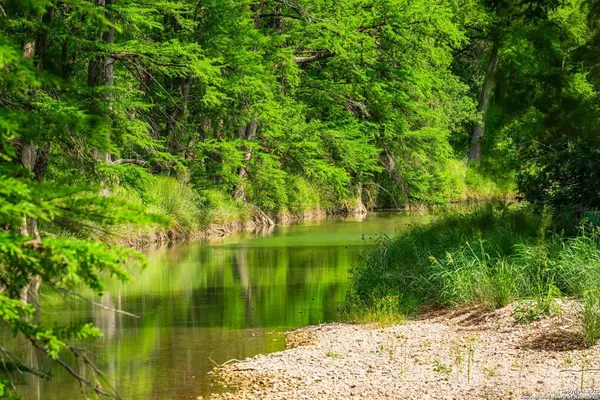 a view of lake background with wooden fence