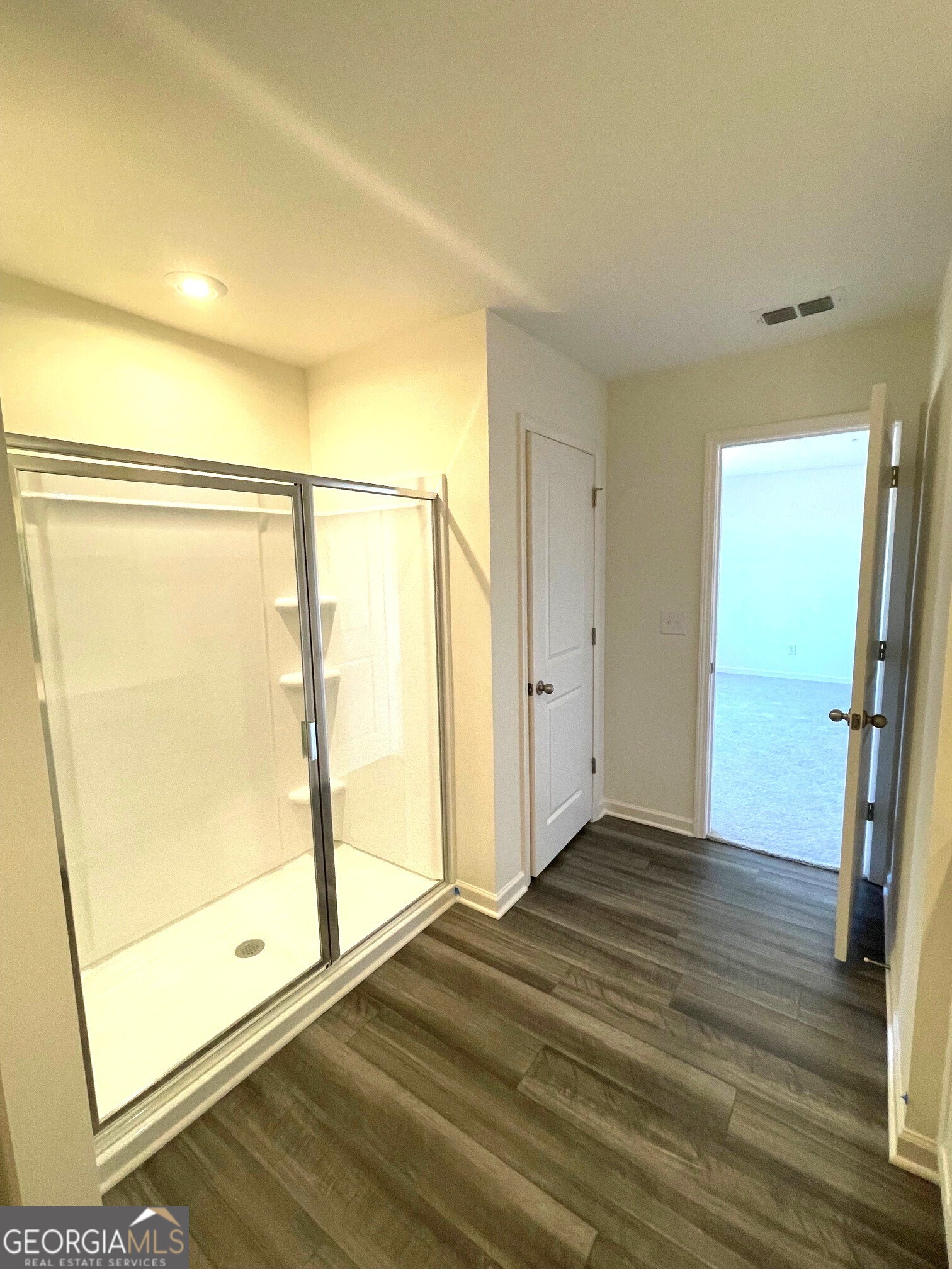 24 Rowlett Place Winder, GA 30680 - Photo 11 of 17 a view of an empty room with wooden floor and a window