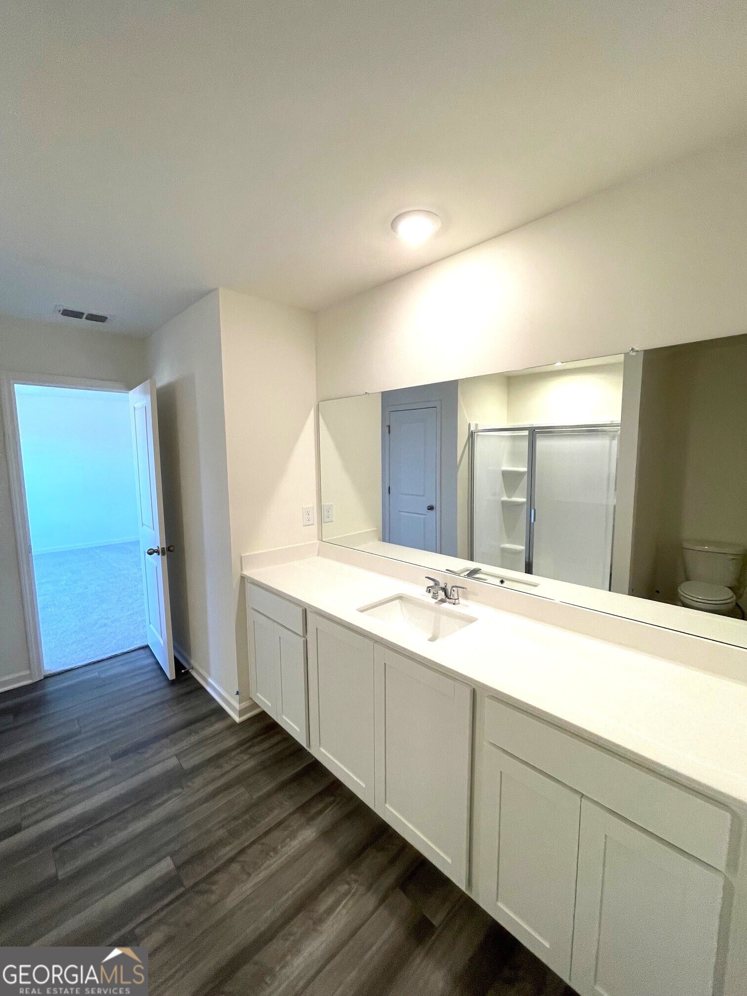 24 Rowlett Place Winder, GA 30680 - Photo 8 of 17 a bathroom with a double vanity sink and mirror