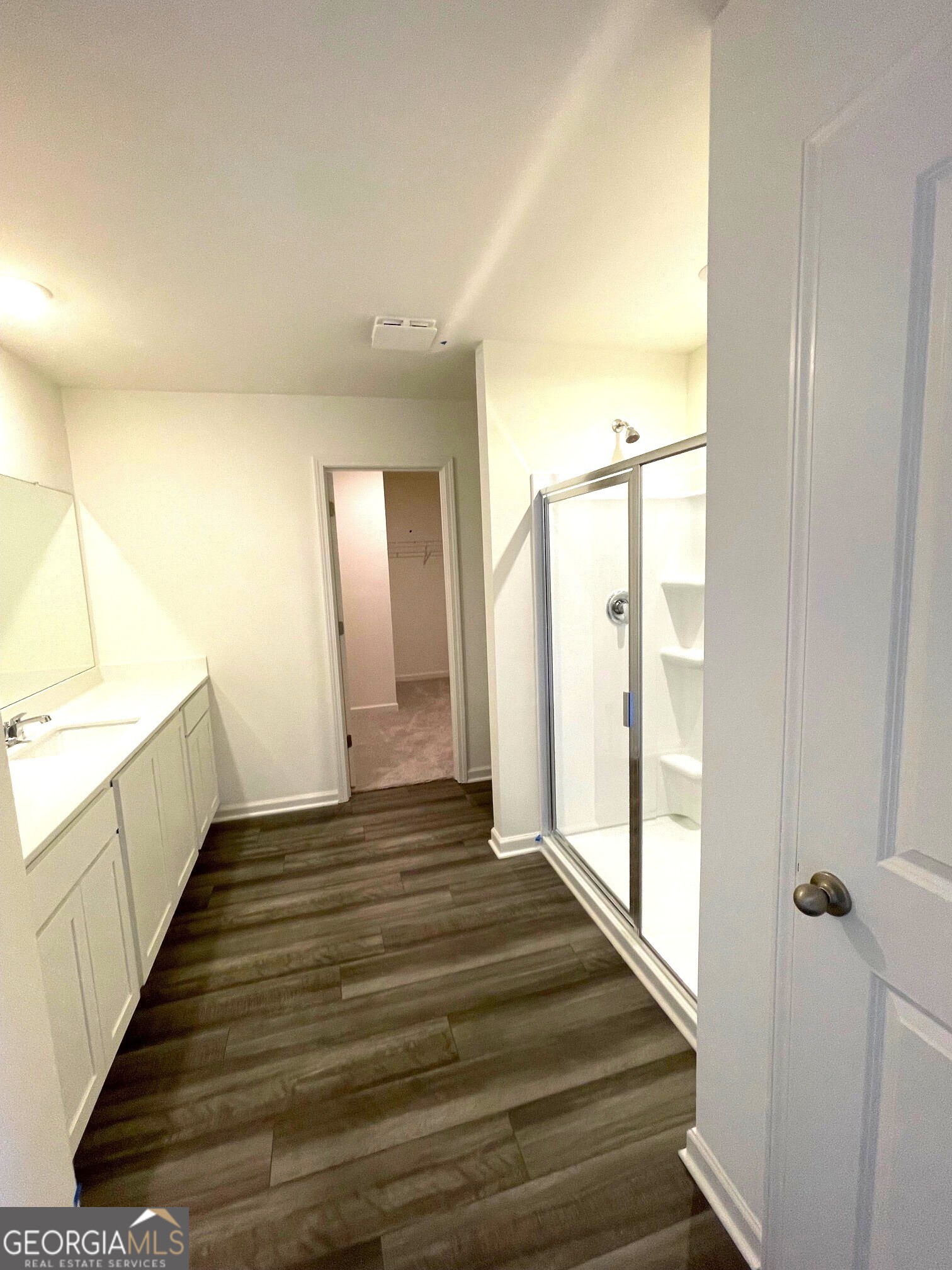 24 Rowlett Place Winder, GA 30680 - Photo 9 of 17 a view of a hallway with wooden floor and staircase
