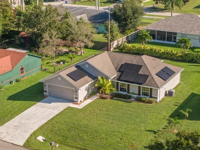 an aerial view of a house with a yard