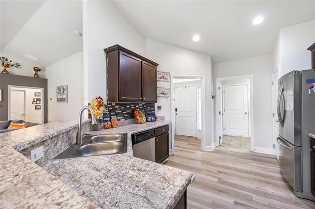 a view of a kitchen and refrigerator in kitchen