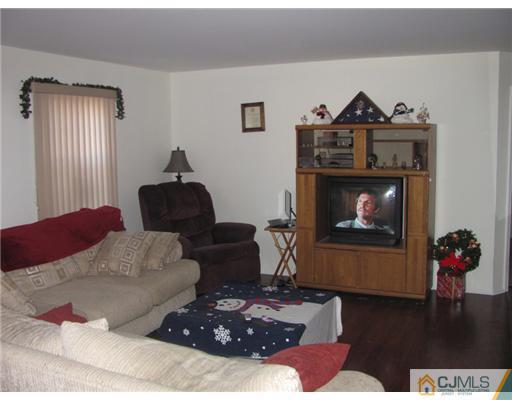 111 Orlando Street Edison, NJ 08817 - Photo 3 of 5 a living room with furniture and wooden floor