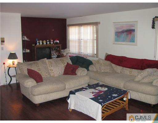111 Orlando Street Edison, NJ 08817 - Photo 4 of 5 a living room with furniture and a fireplace