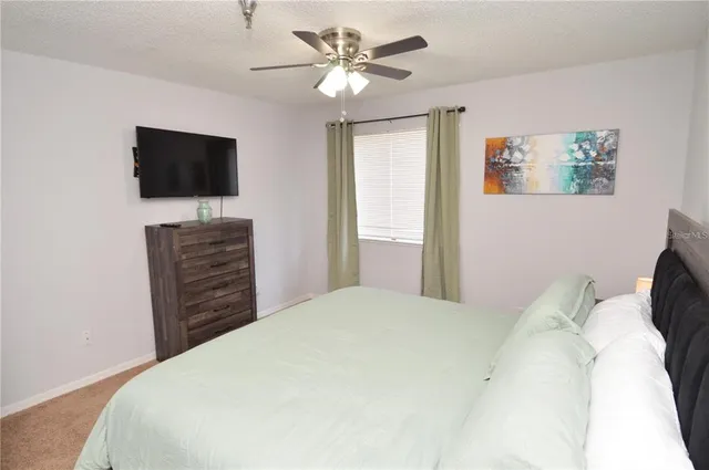 a kitchen with granite countertop a stove a sink a counter top space and cabinets