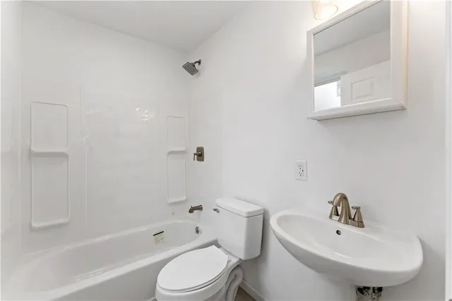 a bathroom with a toilet a sink and bathtub