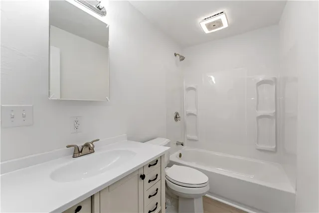 a bathroom with a sink a toilet and a bathtub