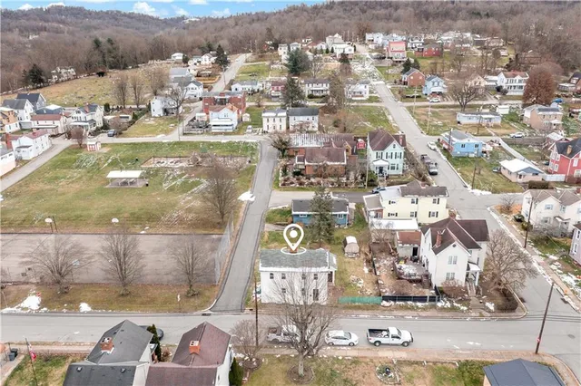 an aerial view of residential houses with outdoor space
