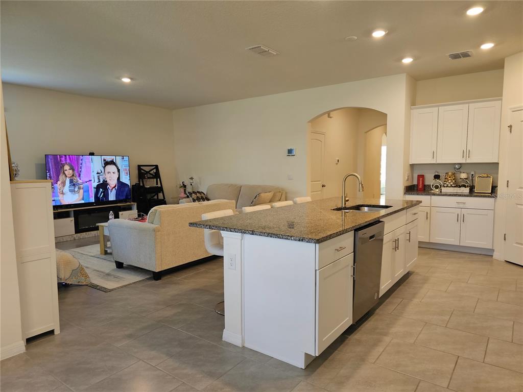 2045 Rankin Street Kissimmee, FL 34744 - Photo 11 of 38 a kitchen with granite countertop a sink and a stove top oven