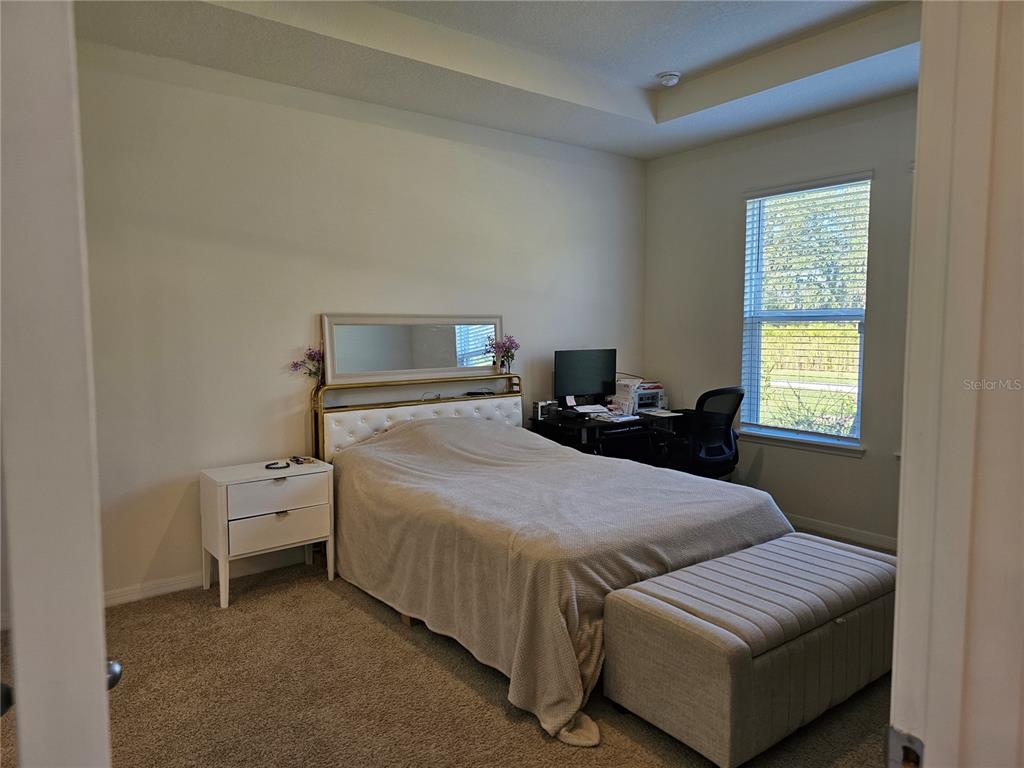 2045 Rankin Street Kissimmee, FL 34744 - Photo 13 of 38 a bedroom with a bed and a couch