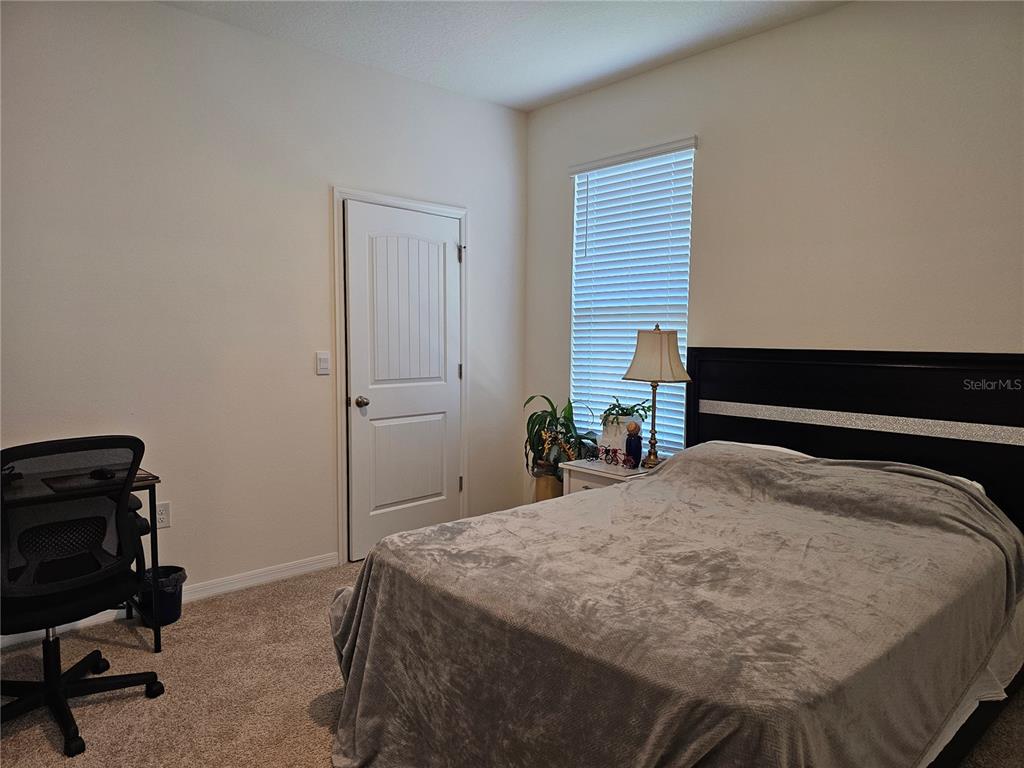 2045 Rankin Street Kissimmee, FL 34744 - Photo 17 of 38 a bedroom with a bed and a desk