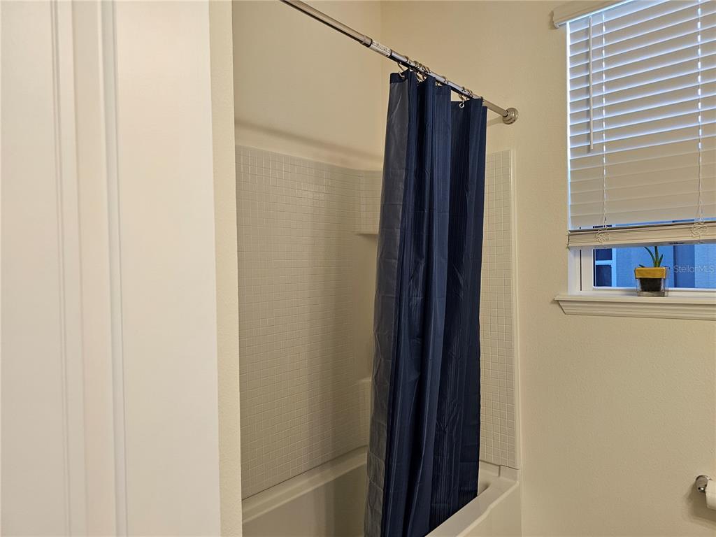 2045 Rankin Street Kissimmee, FL 34744 - Photo 19 of 38 a bathroom with a shower and a tub