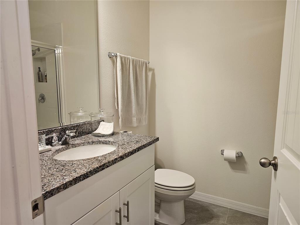 2045 Rankin Street Kissimmee, FL 34744 - Photo 20 of 38 a bathroom with a granite countertop sink and a mirror