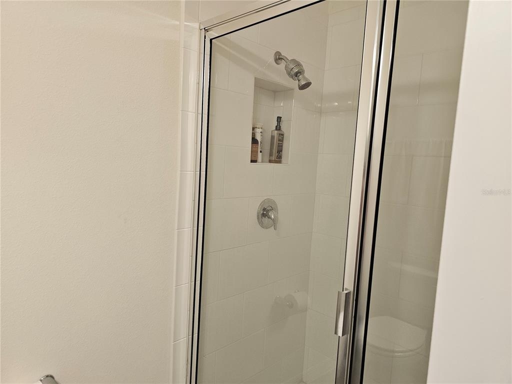 2045 Rankin Street Kissimmee, FL 34744 - Photo 21 of 38 a bathroom with a glass shower door