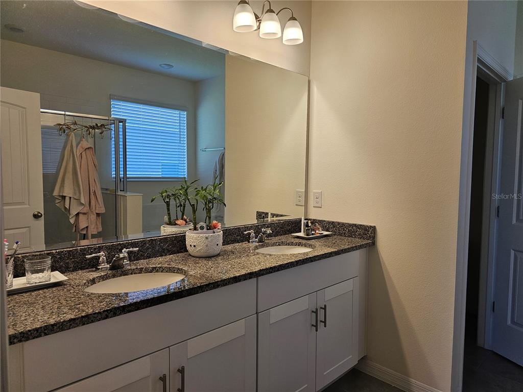 2045 Rankin Street Kissimmee, FL 34744 - Photo 25 of 38 a bathroom with double sink and a mirror