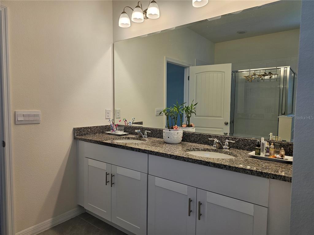 2045 Rankin Street Kissimmee, FL 34744 - Photo 28 of 38 a bathroom with a sink and a mirror