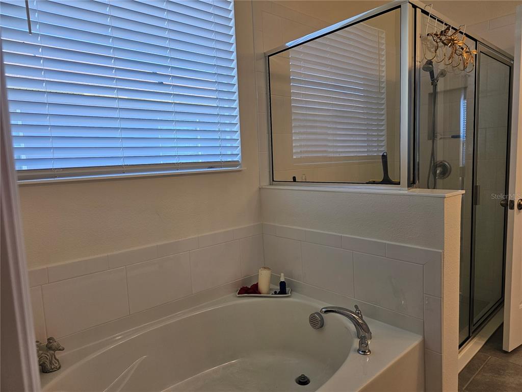 2045 Rankin Street Kissimmee, FL 34744 - Photo 29 of 38 a bathroom with a tub and a shower