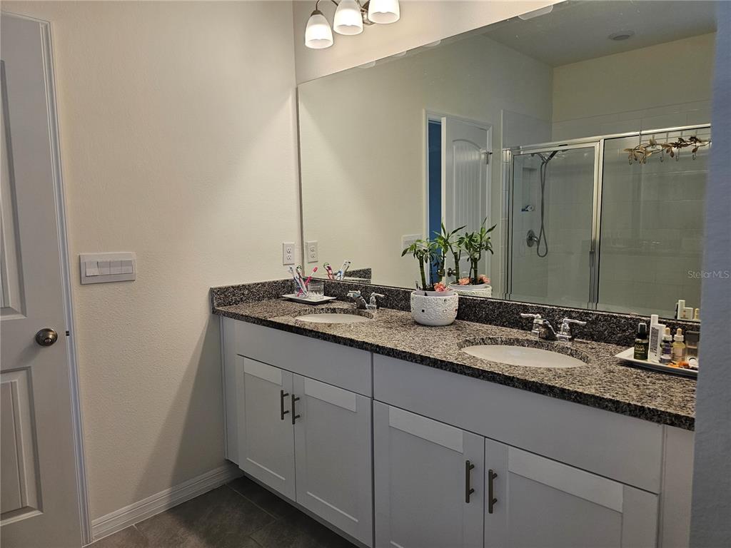 2045 Rankin Street Kissimmee, FL 34744 - Photo 31 of 38 a bathroom with a granite countertop sink and a mirror