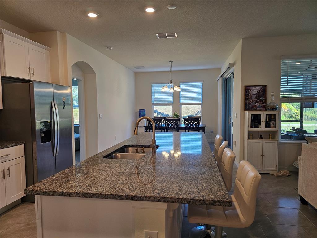 2045 Rankin Street Kissimmee, FL 34744 - Photo 5 of 38 a kitchen with kitchen island granite countertop a counter space cabinets and stainless steel appliances