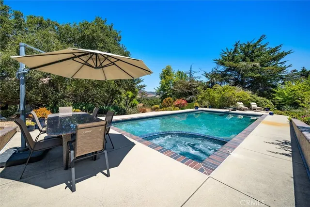 a kitchen with stainless steel appliances granite countertop a sink a stove and a wooden floor