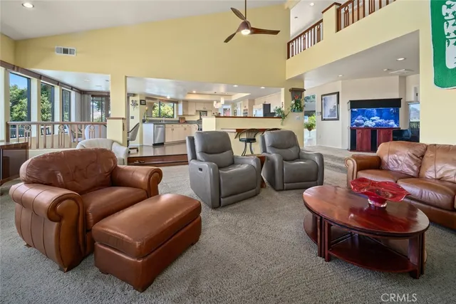 a living room with furniture a chandelier and a window
