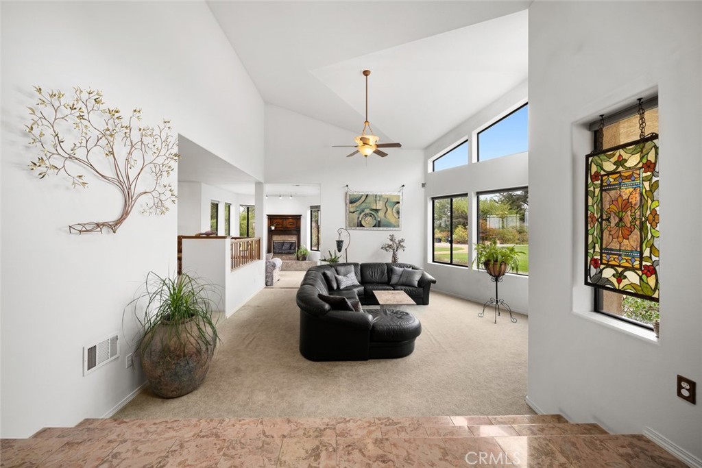 225 Broken Arrow Road Nipomo, CA 93444 - Photo 30 of 75 a living room with furniture potted plant and a chandelier