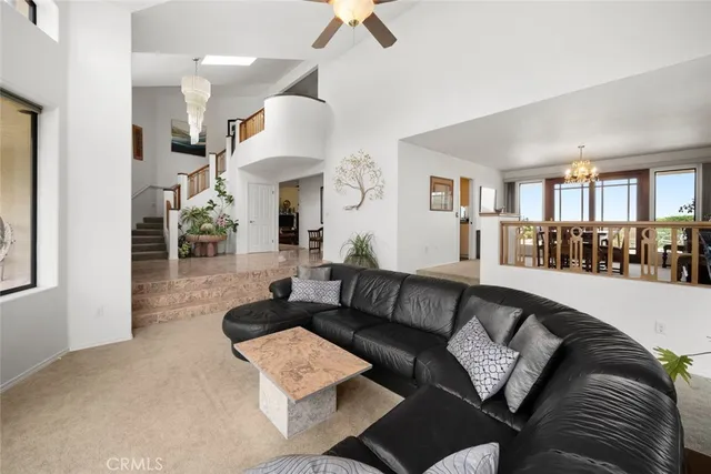 a living room with furniture large windows and garden view