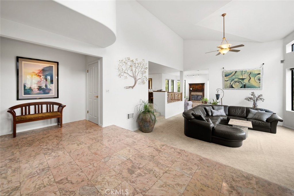 225 Broken Arrow Road Nipomo, CA 93444 - Photo 31 of 75 a living room with furniture a chandelier and a window