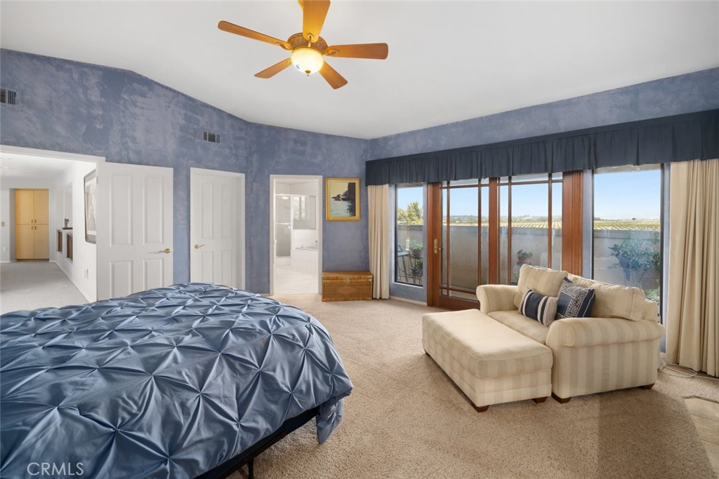 225 Broken Arrow Road Nipomo, CA 93444 - Photo 37 of 75 a spacious bedroom with a bed and glass walk in closet