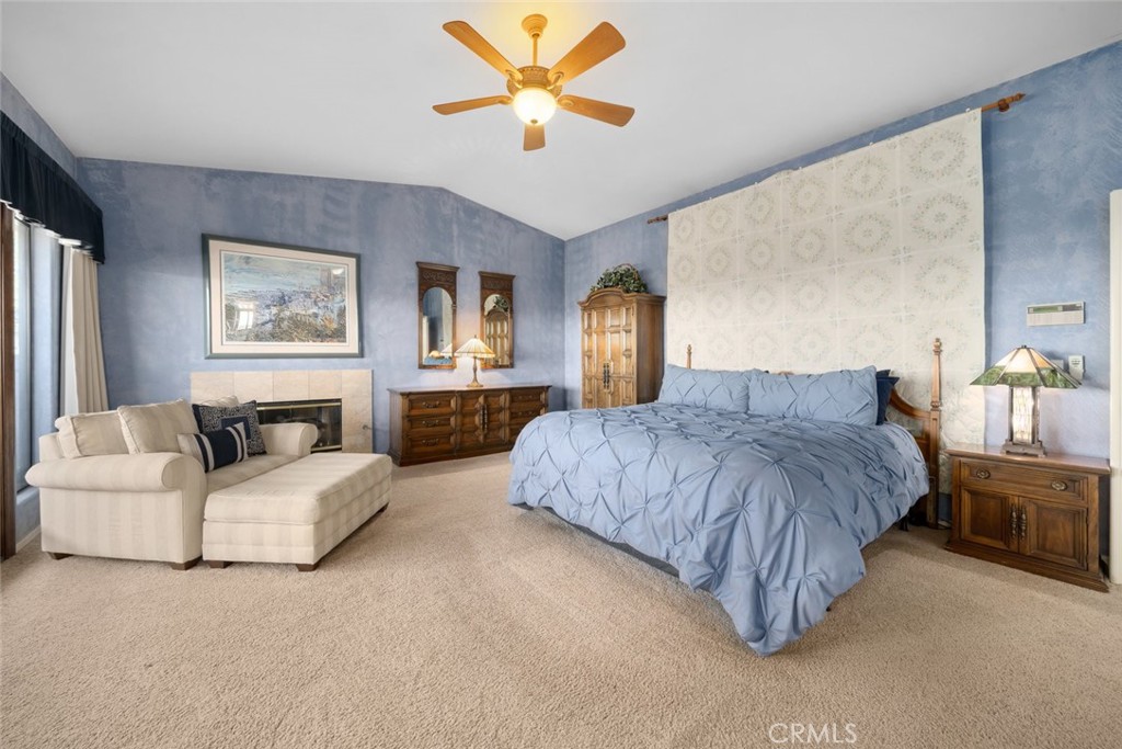 225 Broken Arrow Road Nipomo, CA 93444 - Photo 38 of 75 a spacious bedroom with a large bed and a chandelier