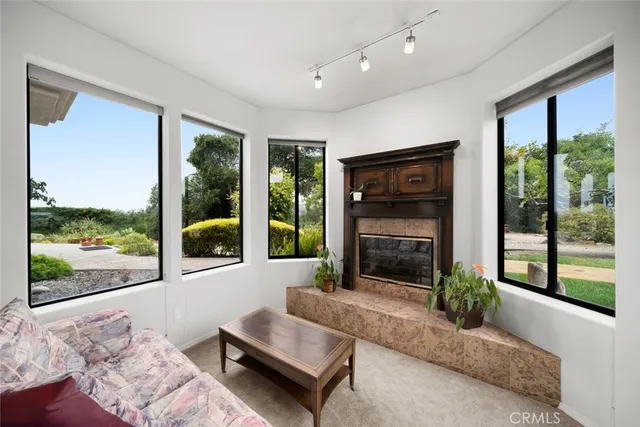 a kitchen with stainless steel appliances granite countertop a sink a counter space wooden floor and a window