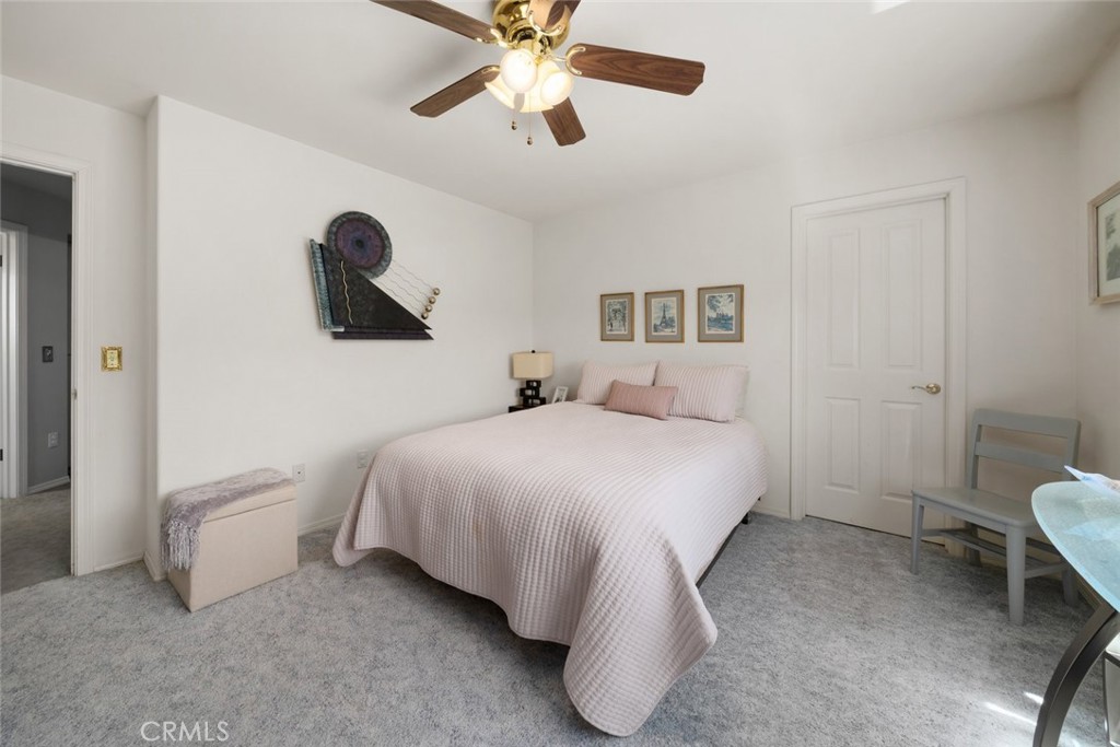 225 Broken Arrow Road Nipomo, CA 93444 - Photo 43 of 75 a bedroom with a bed and a chandelier