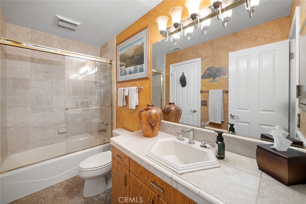 225 Broken Arrow Road Nipomo, CA 93444 - Photo 48 of 75 a bathroom with a sink a toilet and shower