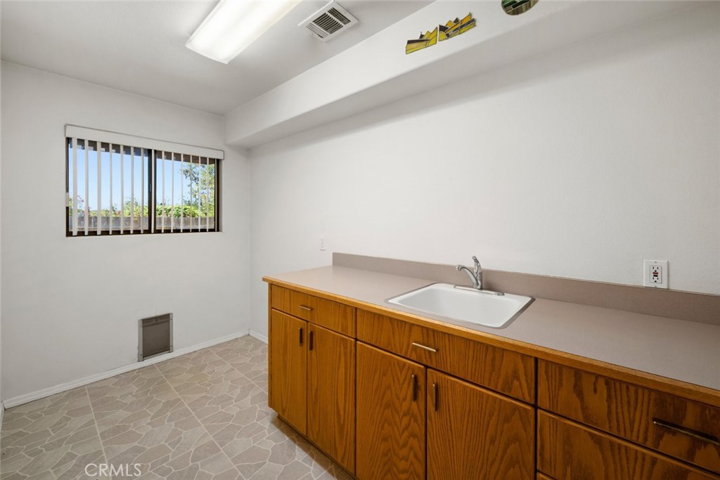 225 Broken Arrow Road Nipomo, CA 93444 - Photo 52 of 75 a bathroom with a granite countertop sink and a mirror
