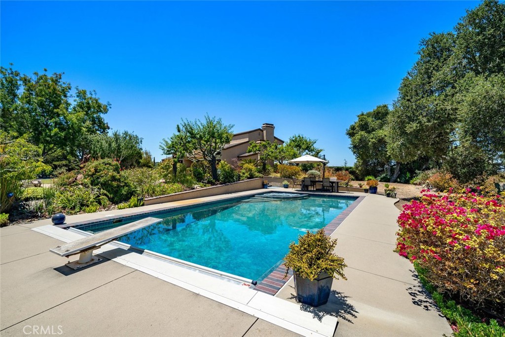 225 Broken Arrow Road Nipomo, CA 93444 - Photo 55 of 75 a view of a swimming pool and lounge chair