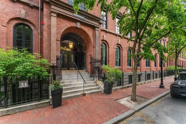 a view of a brick house with a iron gate