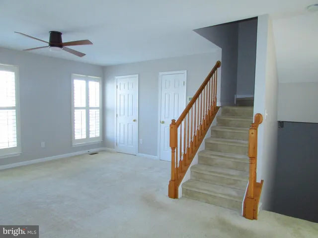 a view of an empty room with stairs