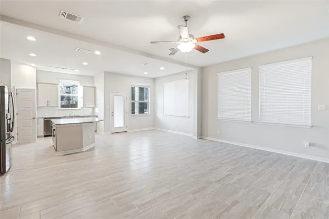 a view of a kitchen with refrigerator and windows