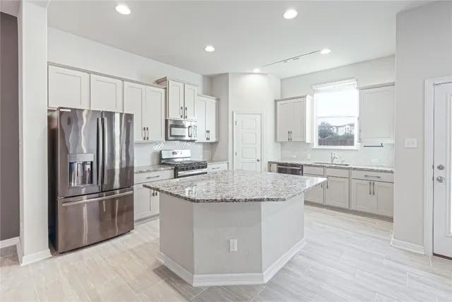 a view of kitchen with wooden floor and window