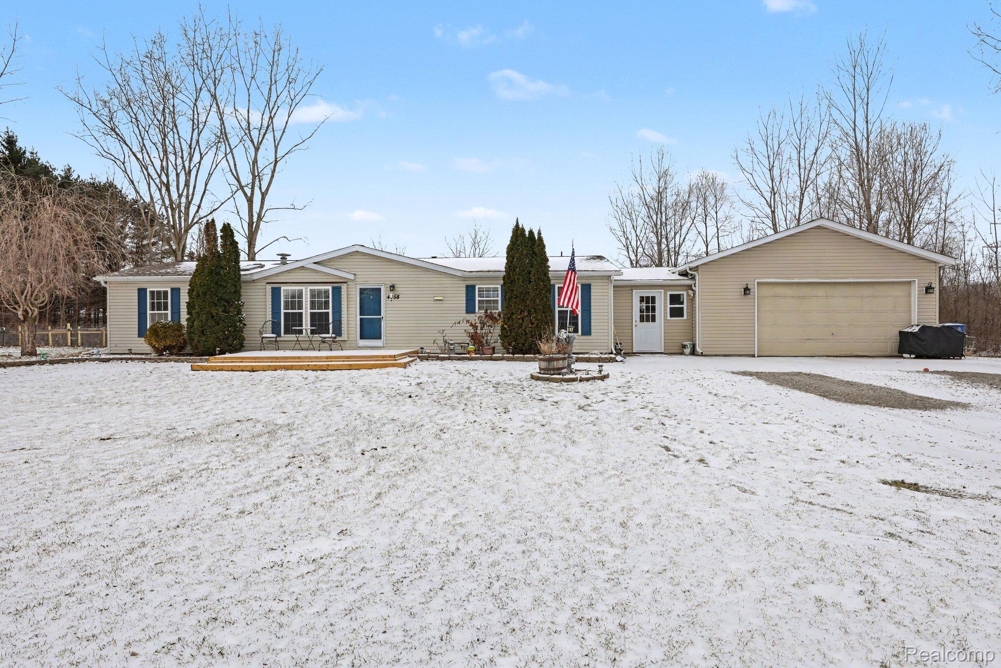 4458 Palms Road Casco, MI 48064 - Photo 28 of 32 Ranch-style house with an attached garage and a deck