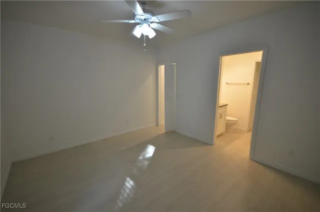 a view of a livingroom with a chandelier fan and a window