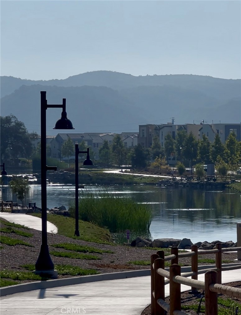 731 Jasper Street Rancho Mission Viejo, CA 92694 - Photo 12 of 14 a view of a lake in front of residential houses