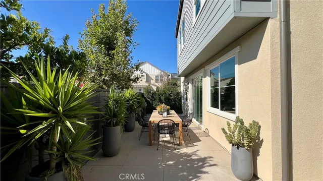 a house with potted plants in front of it