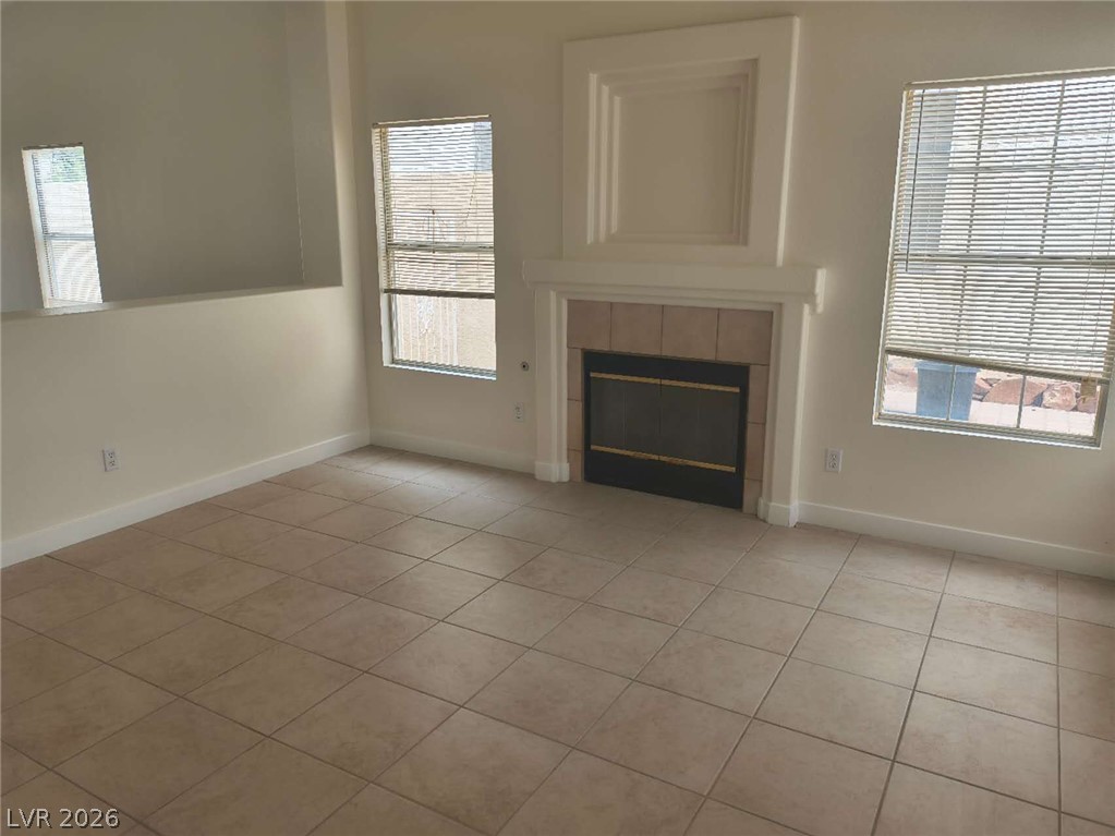 9725 Pima Point Avenue Las Vegas, NV 89147 - Photo 4 of 35 A well-proportioned living area features durable tile flooring and an inviting fireplace.